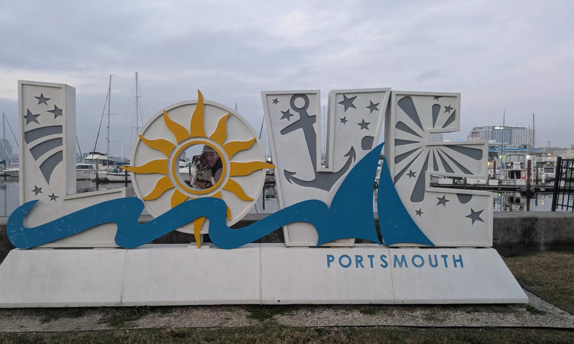 Nic and Kiwi standing behind the "Love Portsmouth" sign in Portmouth, Virginia